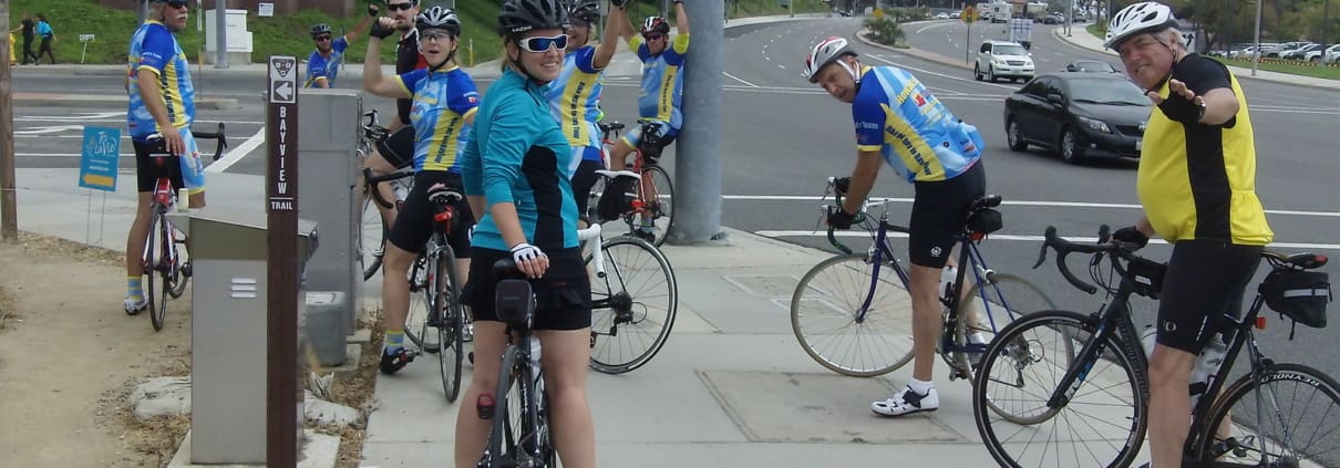 A group of people riding bikes down a street