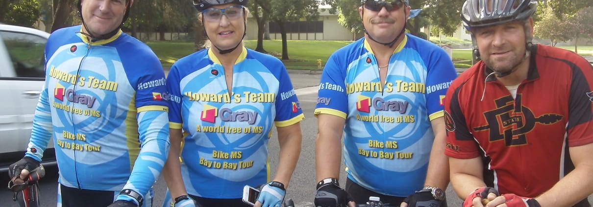 A group of three men riding bikes next to each other