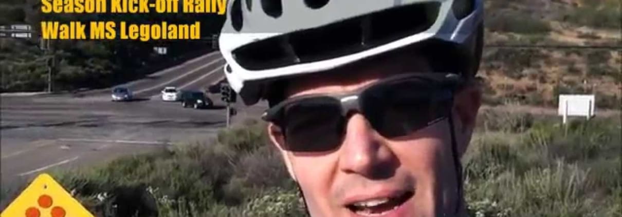 A man wearing a bike helmet and sunglasses