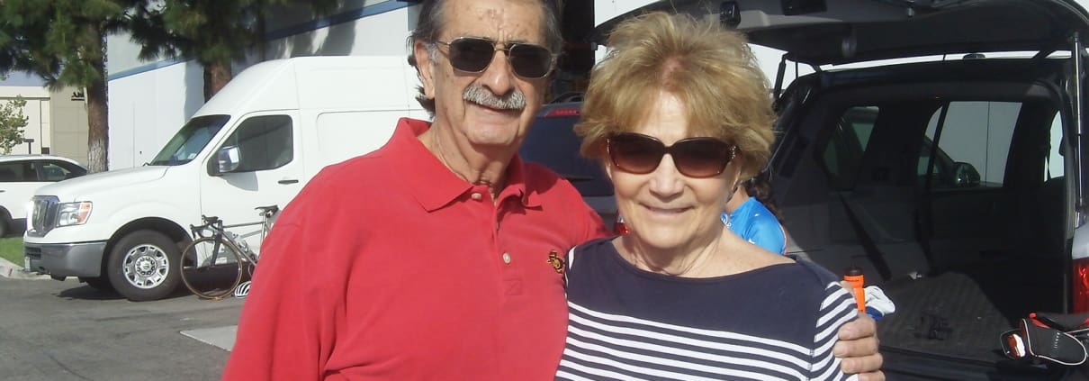 A man and a woman standing next to a van