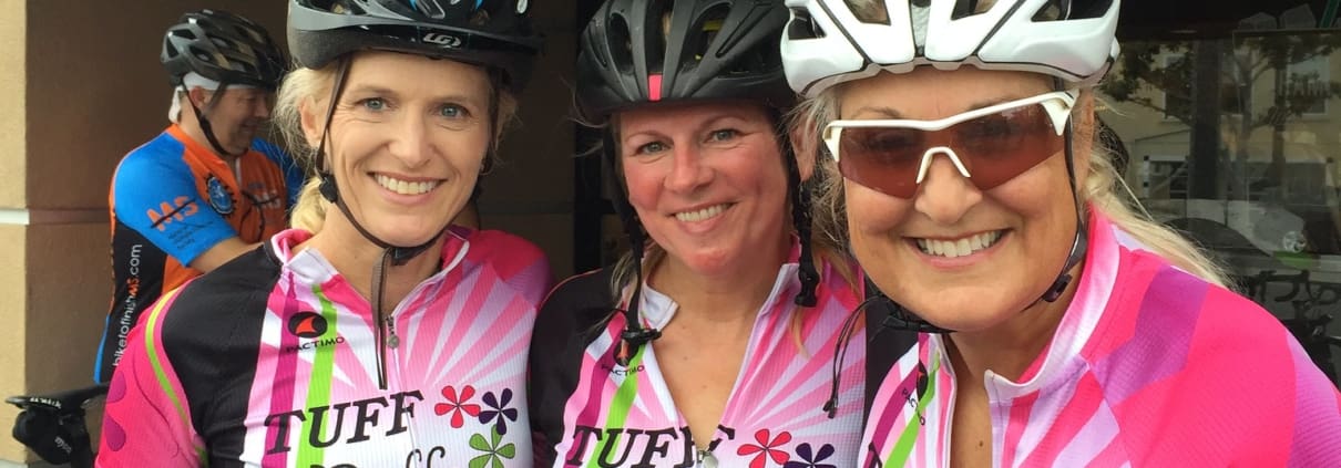 Three women in pink shirts