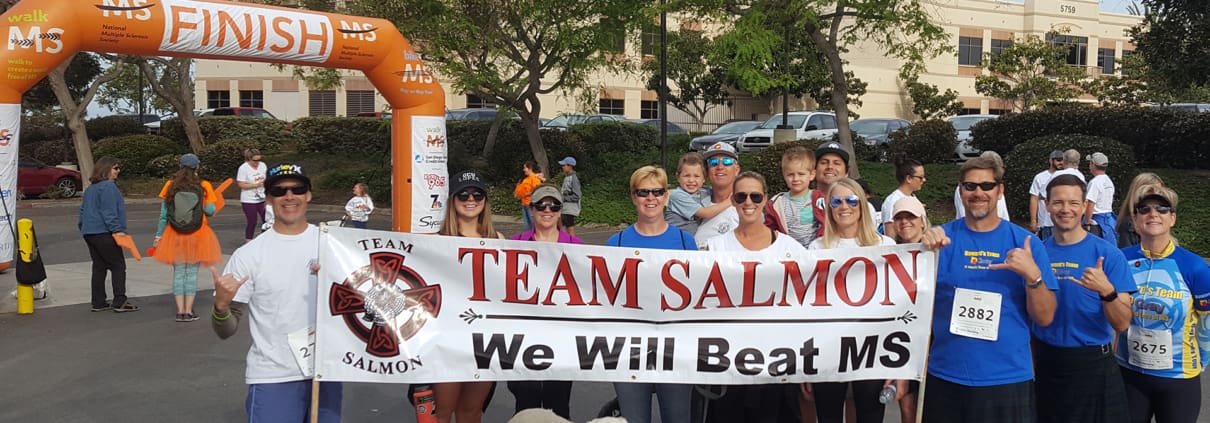 A group of people holding a banner and a dog