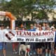 A group of people holding a banner and a dog