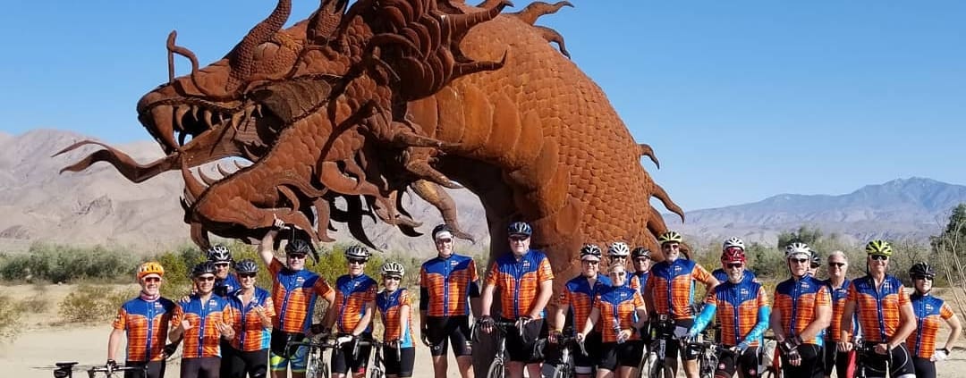 A group of men standing next to each other in front of a giant dragon