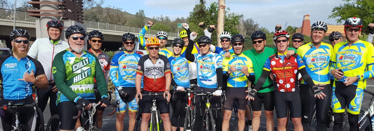 A group of men standing next to each other on bikes