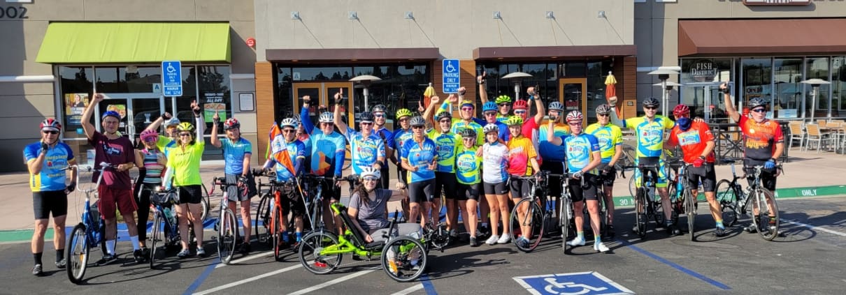 A group of bicyclists standing in front of a building