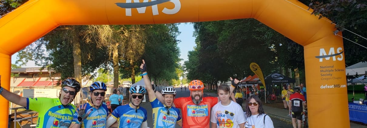 A group of people standing under an orange arch