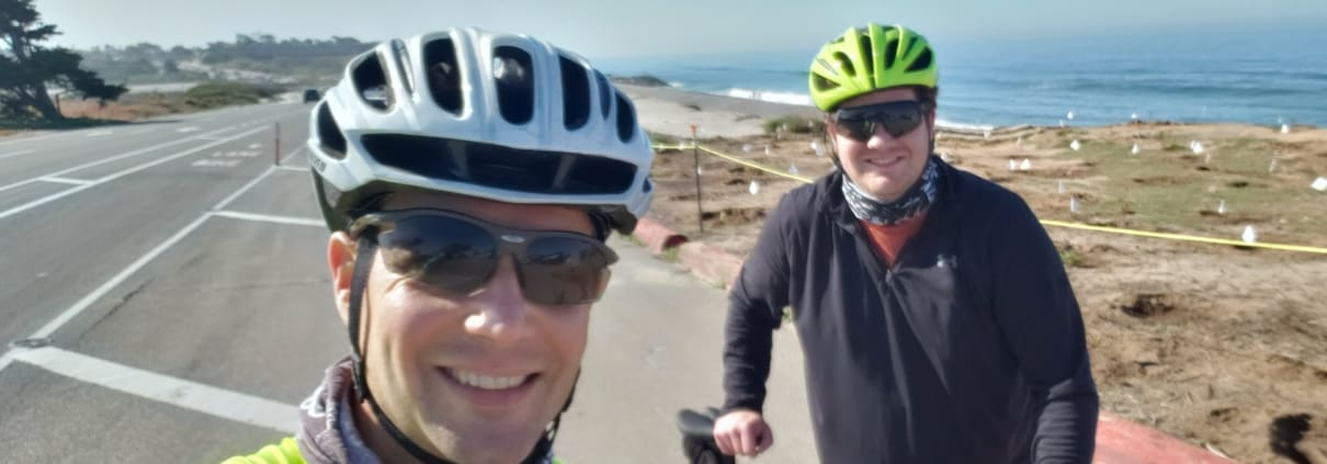 men riding bikes down a street