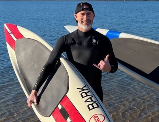 man holding surfboard