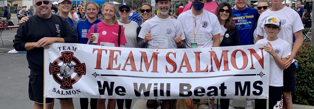 A group of people holding a banner in a parking lot